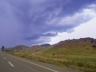  Empty asphalt road to the background blue sky