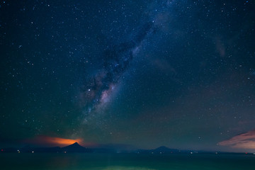 Obraz na płótnie Canvas Wide landscape at night on the shore of Lake Llanquihue. The Milky Way passing through the Osorno and Calbuco volcanoes