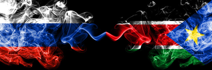 Russian vs South Sudan smoke flags placed side by side. Thick colored silky smoke flags of Russia and South Sudan