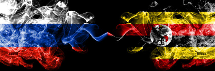 Russian vs Uganda, Ugandan smoke flags placed side by side. Thick colored silky smoke flags of Russia and Uganda, Ugandan