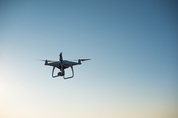 White drone fly in the sky recording a video