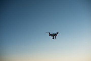 Fototapeta na wymiar White drone fly in the sky recording a video
