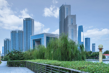 Obraz na płótnie Canvas park pedestrian walkway and modern skyscrapers, dalian city, china.