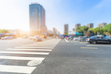 empty road with zebra crossing and buildings in modern city