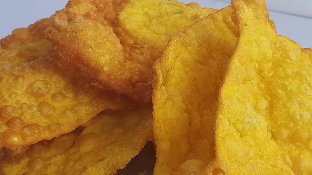 Close up of deep fried wontons served on a plate. Wonton the most popular dim sum food in Chinese restaurants.