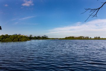 Marapendi Lagoon in Barra da Tijuca district, West Side of Rio de Janeiro, Brazil – Gavea Rock Mountain on the Background