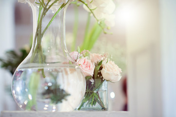 White roses in clear glass vases