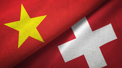 Vietnam and Switzerland two flags textile cloth, fabric texture © Aleks Taurus