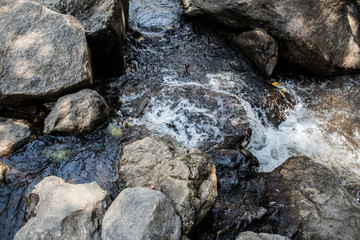 Waterfall in the nature and stone background