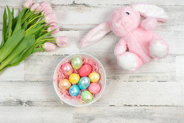 Happy Easter background with eggs, tulips and stuffed bunny