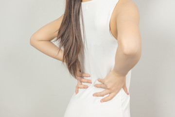 Obraz premium A woman held her hand behind him with back pain. Healthcare concept