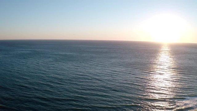 Point Dume, Malibu Beach Aerial Flying into Sunset Over Pacific Ocean
