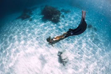 Attractive woman freediver with fins. Freediving underwater in Hawaii