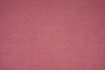 Fototapeta premium The texture of the knitted red fabric for the background 