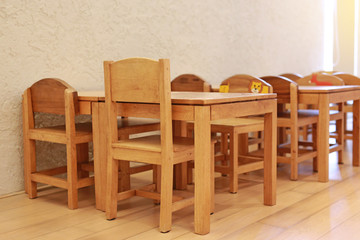 Small desk and chairs for kid in student classroom.