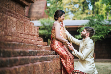 Asian bride and Caucasian groom have romantic time with Thailand dress