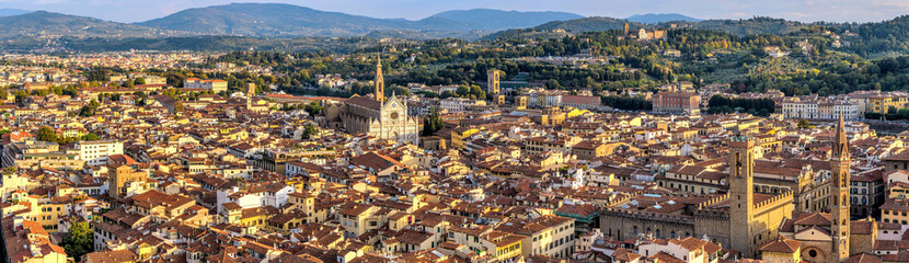 Fototapeta na wymiar Autumn Sunset at Florence - Golden sunlight of Autumn sunset shines on south side of the historical Old Town of Florence, Tuscany, Italy. No recognizable trademark, logo or person in the image. 