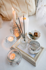 still life with interior details and burning candles in the living room, the concept of home comfort and interior, romantic gift boxes