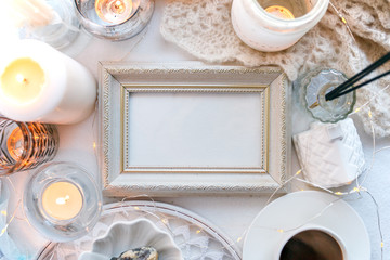 Beautiful candles, cup of coffee on white background, frame for your text, flat lay, top view, relax morning concept