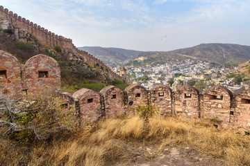 Fototapeta premium Ancient long wall with towers around Amber Fort and view of Amber village. Rajasthan. India
