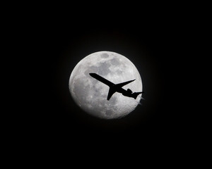 Airliner Passing in Front of a Full Moon