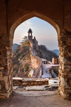 Ancient long wall with towers around Amber Fort through the arch of tower  walls at morning. Rajasthan. India Stock Photo | Adobe Stock