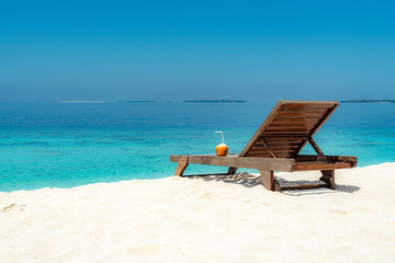 Coconut on the wooden bed at the white sand beach
