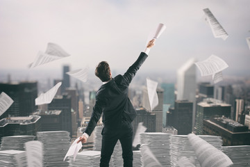 Businessman tired of bureaucracy throws up sheets of paper in the air