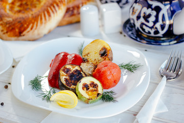 White plate with grilled vegetables.