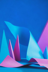 Papercraft shapes, pyramids, and curves in abstract paper sculpture. Design template with real 3D forms in traditional materials.