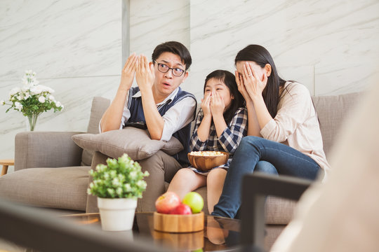 Happy Asian Family Lifestyle Enjoy Watching TV Scary Movies At Home