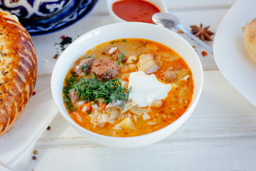 Mastava - uzbek rice soup on white table.