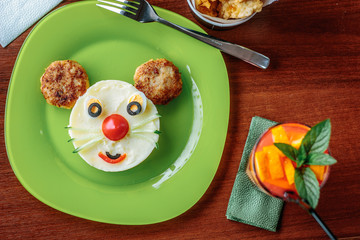 Top view of kid food - funny face made from potato puree and meat.