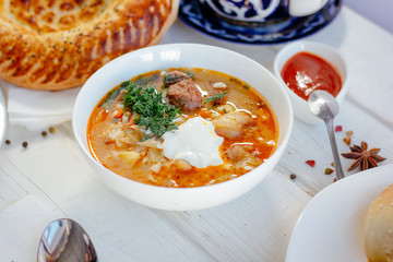 Mastava - uzbek rice soup on white table.