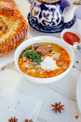Mastava - uzbek rice soup on white table.