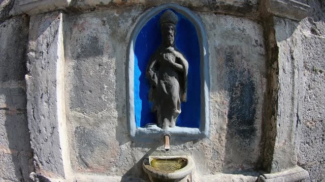 Colzate, Bergamo, Italy. Water spurting from the fountain outside of the shrine of St. Patrick (San Patrizio in Italian)