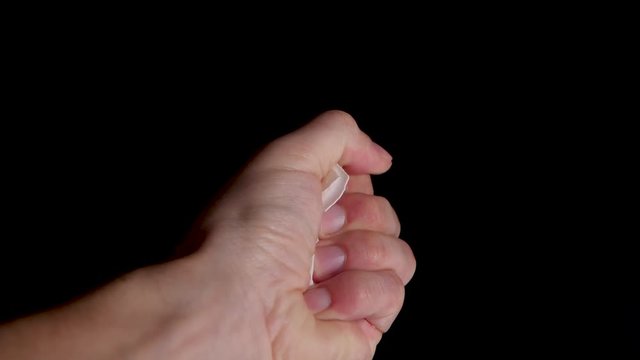 Close up of crushing a empty egg shell in a bare fist in slow motion.