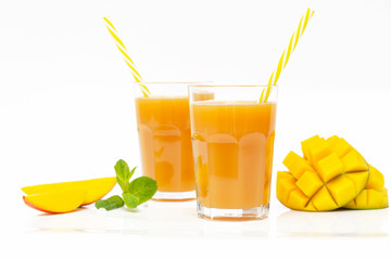 Fresh tropical fruit smoothie mango juice and fresh mango on a white background. Copy space.