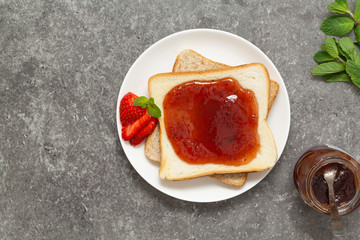 Fresh strawberry jam with toast for breakfast. Top view