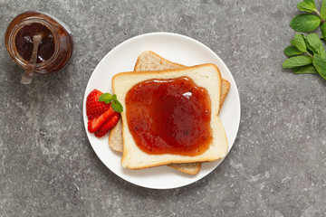 Fresh strawberry jam with toast for breakfast. Top view