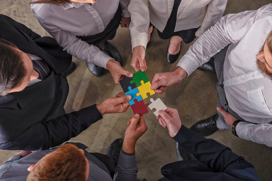 Teamwork of partners. Concept of integration and startup with puzzle pieces.