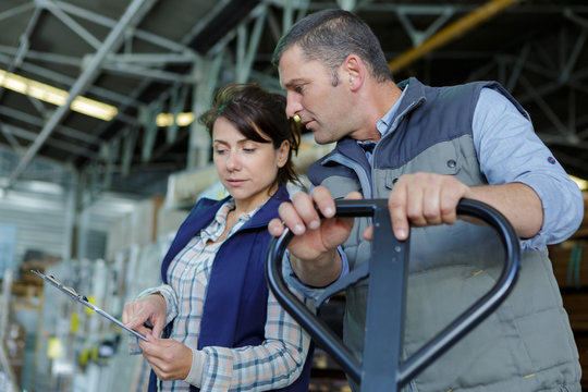 warehouse workers studying the orders