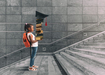 Little girl with backpack on her shoulder, and books in hand, who undertakes a training course thinking about graduation