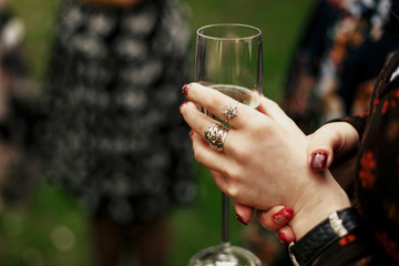 luxury elegant woman holding glass of champagne at celebration in restaurant terrace, rich feast outdoors