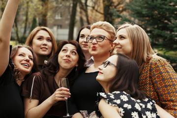 stylish elegant women taking funny selfie at celebration sunny in park, luxury happy life concept