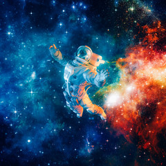 Among the stars / 3D illustration of science fiction scene with astronaut floating in outer space amid glowing colourful galaxies