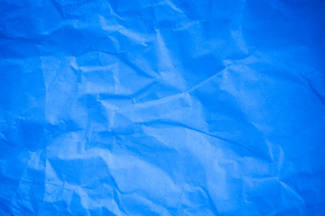 Crumpled blue paper background.