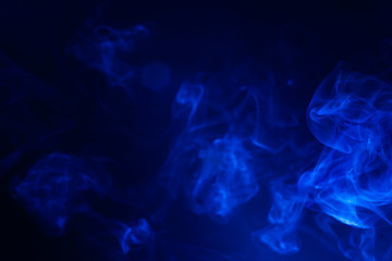 Blue smoke on black background.