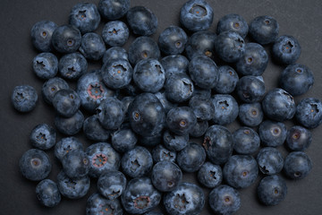 Fototapeta na wymiar Closeup view of fresh blueberry on black background
