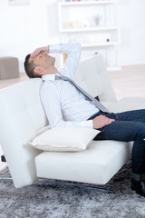 Fototapeta premium stressed businessman sleeping on the couch